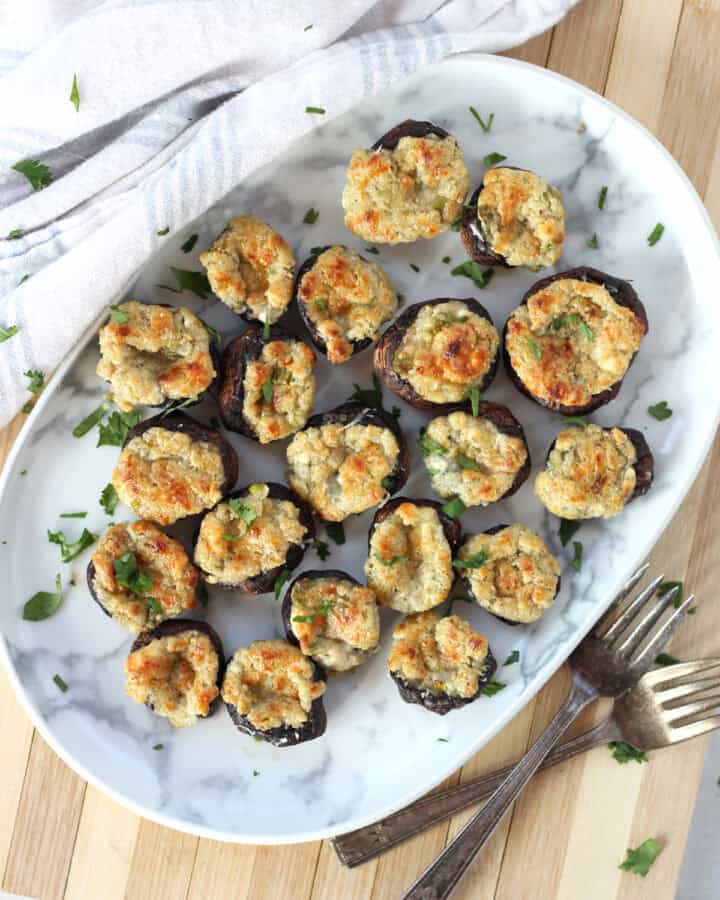 Mushrooms stuffed with blue cheese served on a plate.