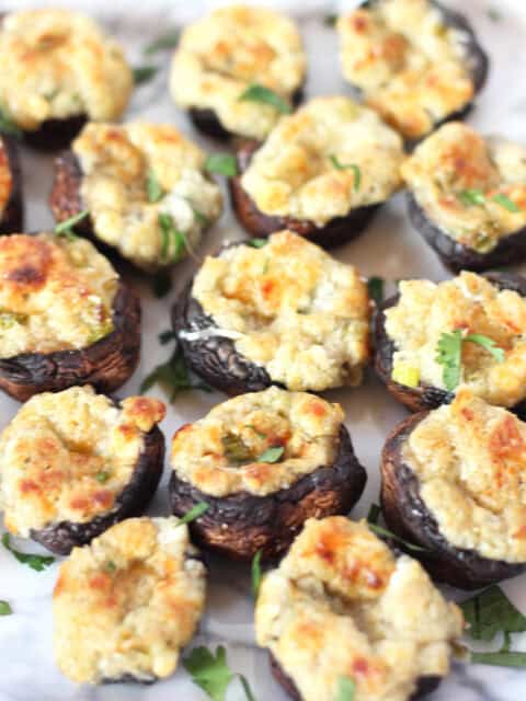 Baked stuffed mushrooms garnished with fresh parsley.