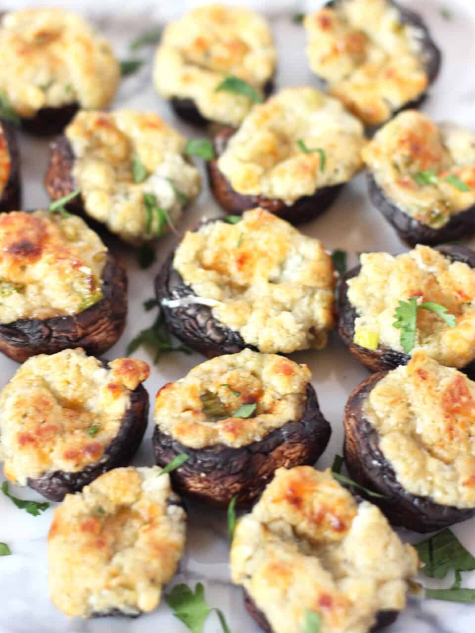 Baked stuffed mushrooms garnished with fresh parsley.