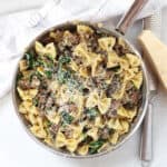Cooked beef and mushroom pasta recipe topped with shredded parmesan