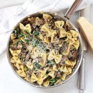 Cooked beef and mushroom pasta recipe topped with shredded parmesan