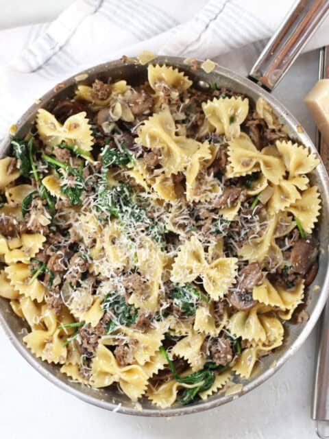Cooked beef and mushroom pasta recipe topped with shredded parmesan