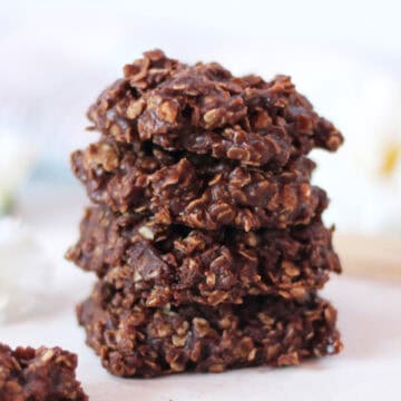 No bake chocolate peanut butter cookies stacked on top of each other.