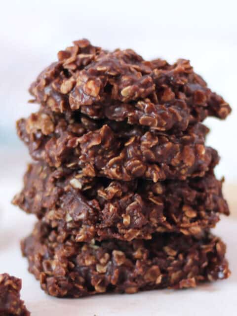 No bake chocolate peanut butter cookies stacked on top of each other.