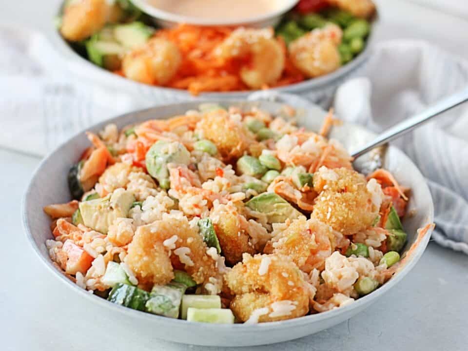 Bowl with rice, breaded shrimp and vegetables.