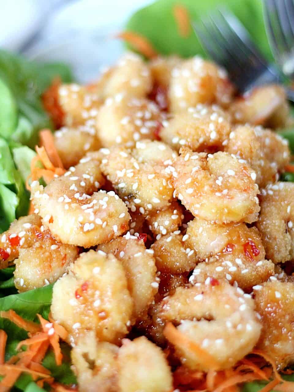 Sweet chili crispy shrimp garnished with sesame seeds.