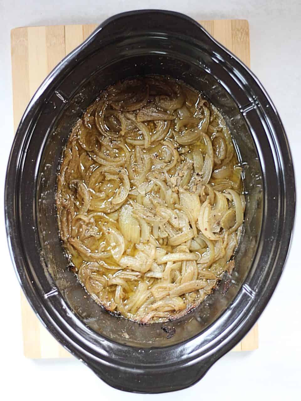 Cooked onions in a slow cooker.