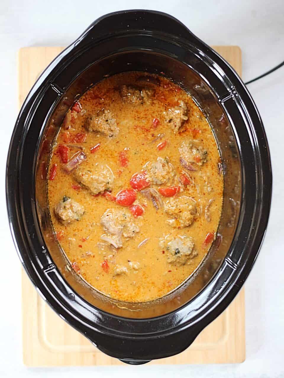 Curry and meatballs in a slow cooker.